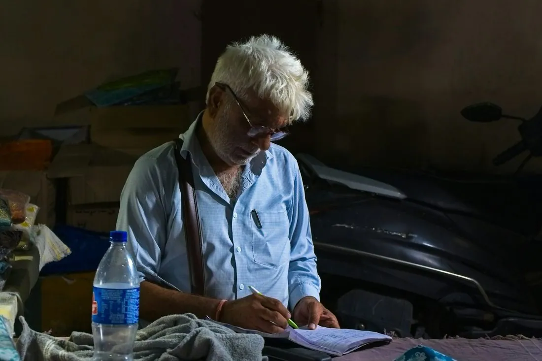 A man filling in a paper register by hand