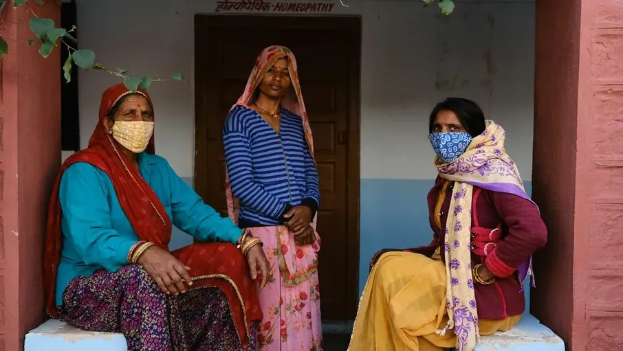 Three women standing in a doorway