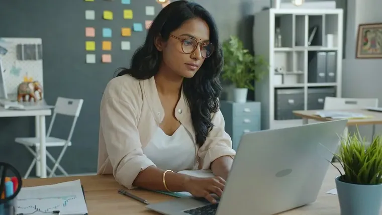 A woman working at a laptop
