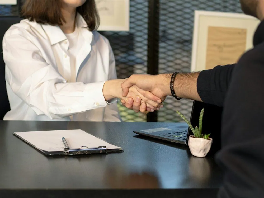 A handshake across a desk