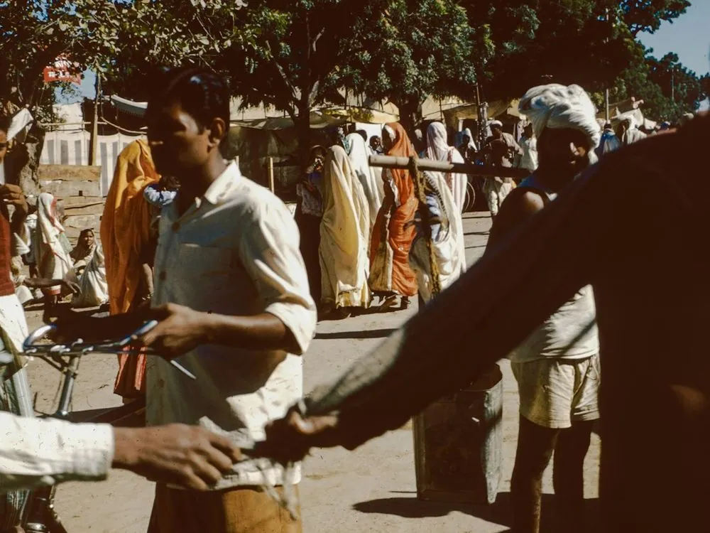 Men weighing produce at a market yard