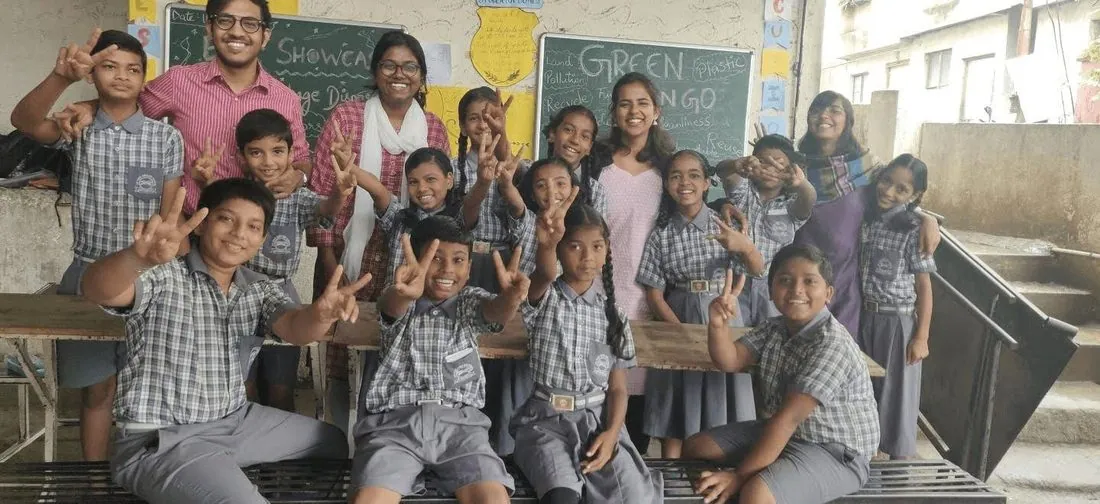 Schoolchildren waving from their classroom