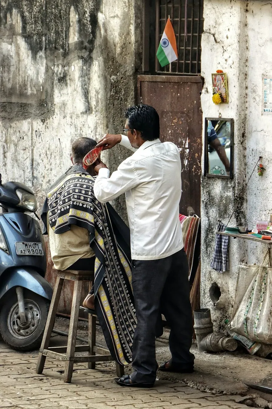 A health worker drinking water beside her motorcycle