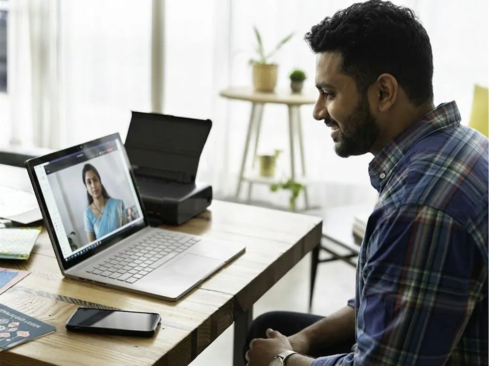 A man on a video call at his laptop