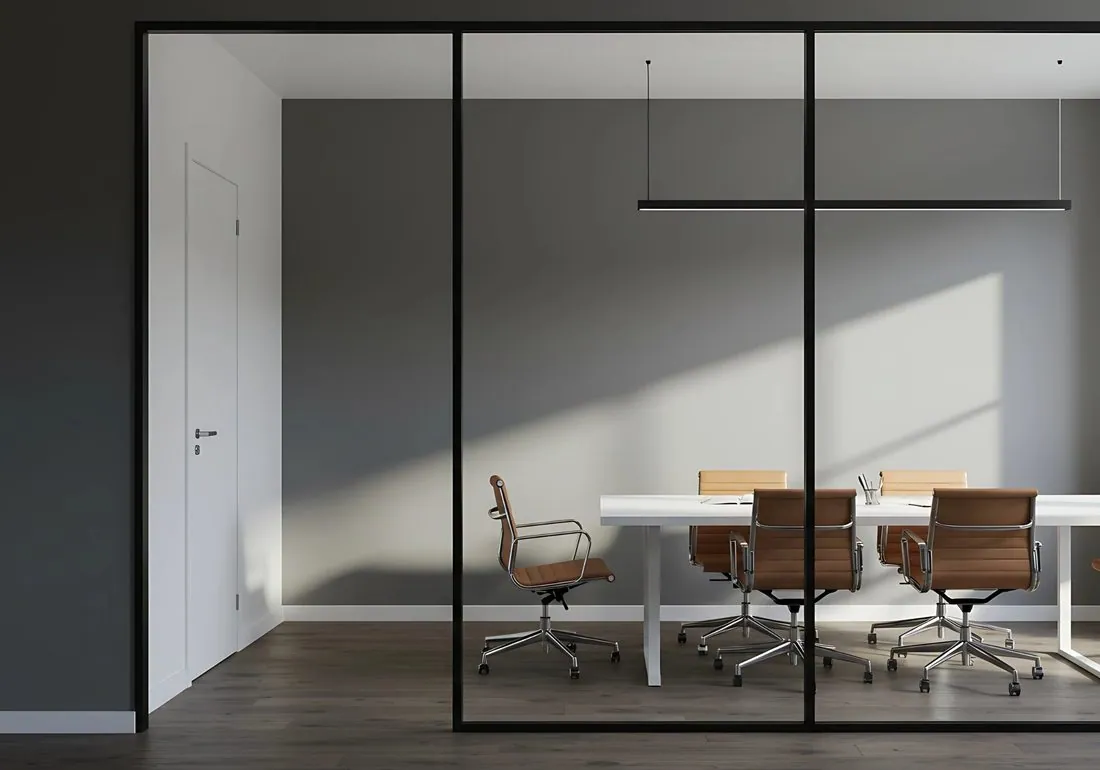 A glass-walled meeting room with the commons.inc logo on the glass