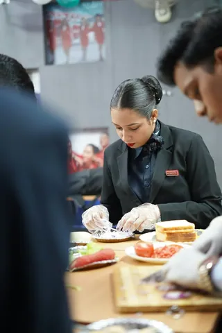 A woman in uniform working at a desk