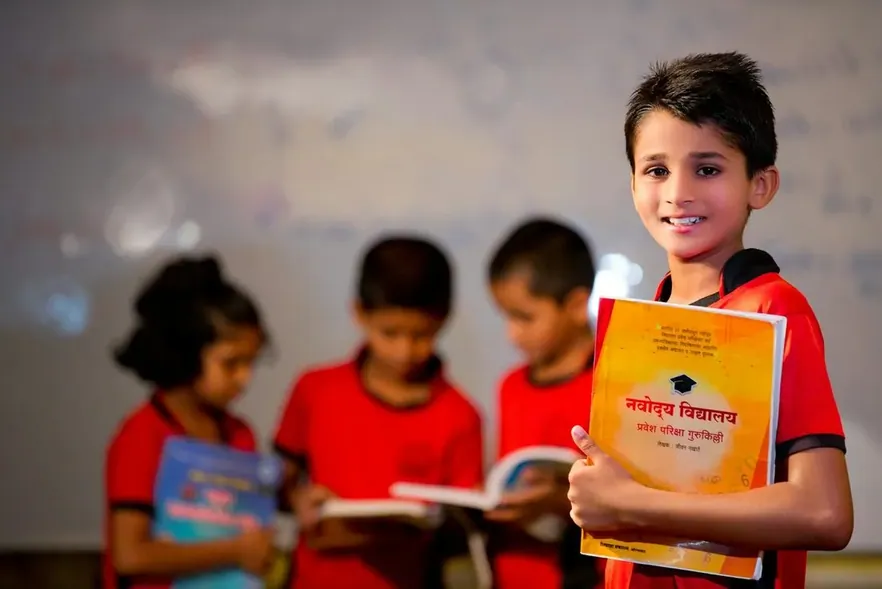 A boy holding up a book
