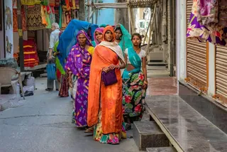 Women walking a narrow market lane