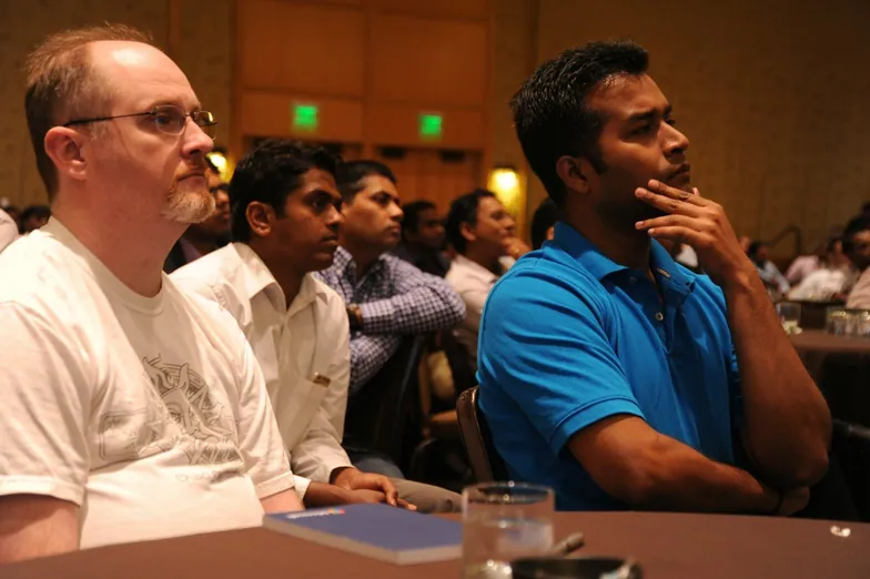 Colleagues listening in a meeting room