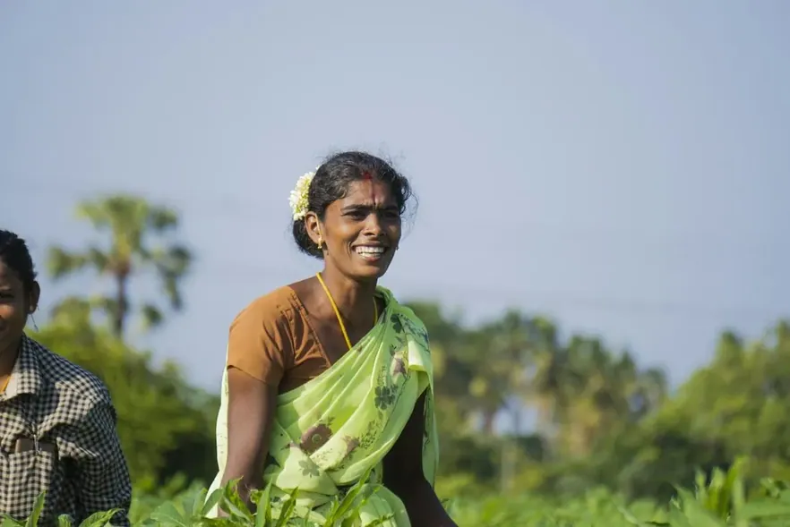 A farmer smiling in her field