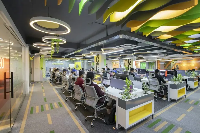 An open-plan office of empty desks