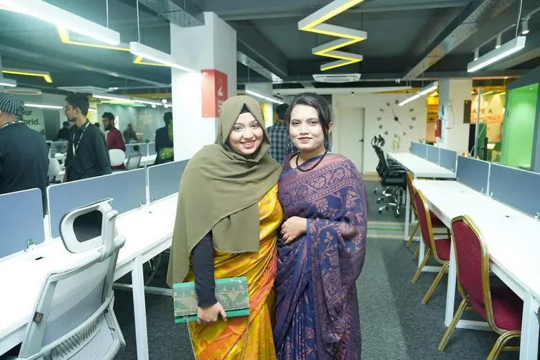 Two women standing together in an office