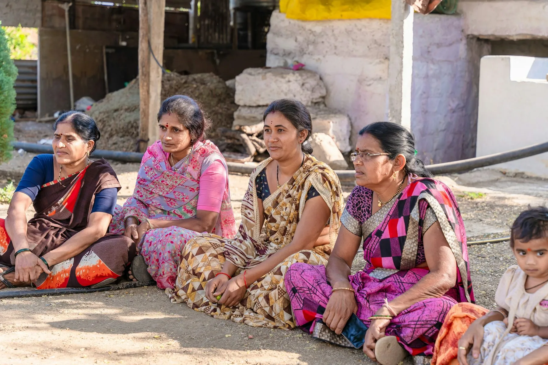 Women seated on the ground outside