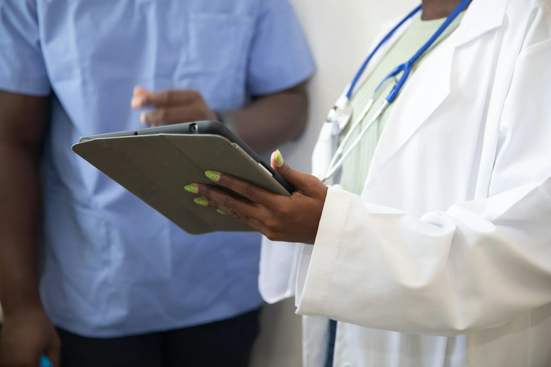 A clinician holding a tablet
