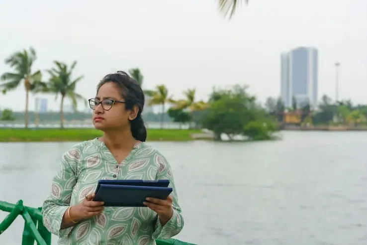 A woman with a tablet outdoors