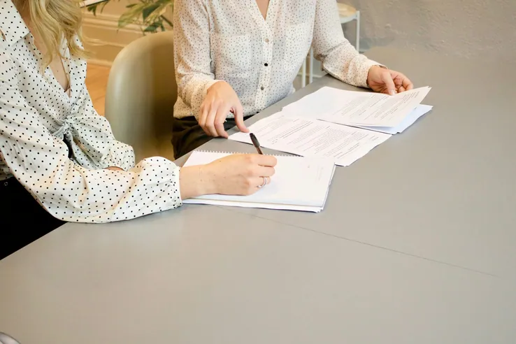 Two people going through papers at a table