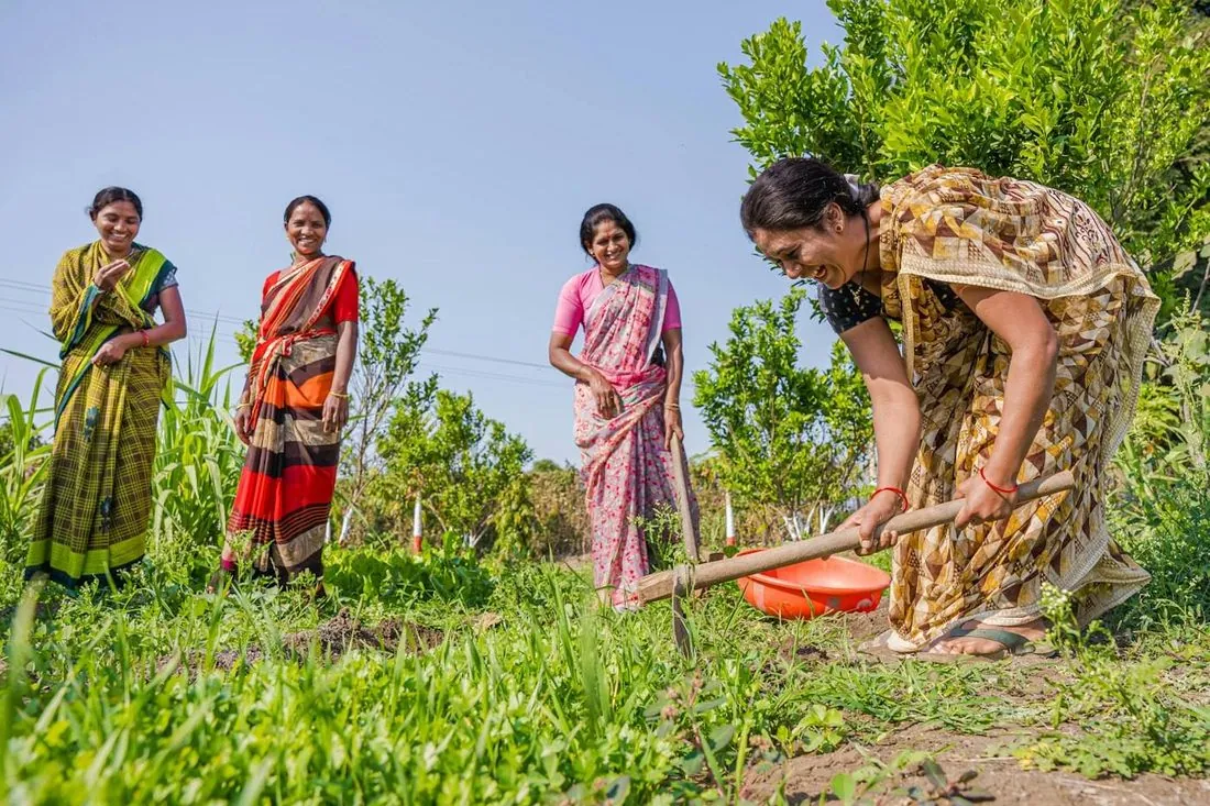 A field team working alongside women farmers