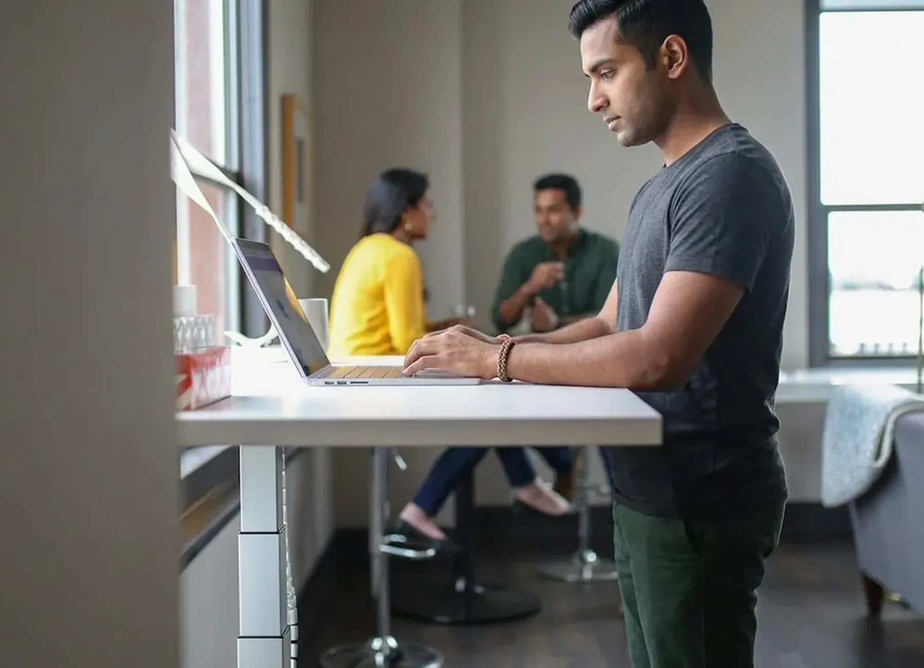 A man working standing at his desk
