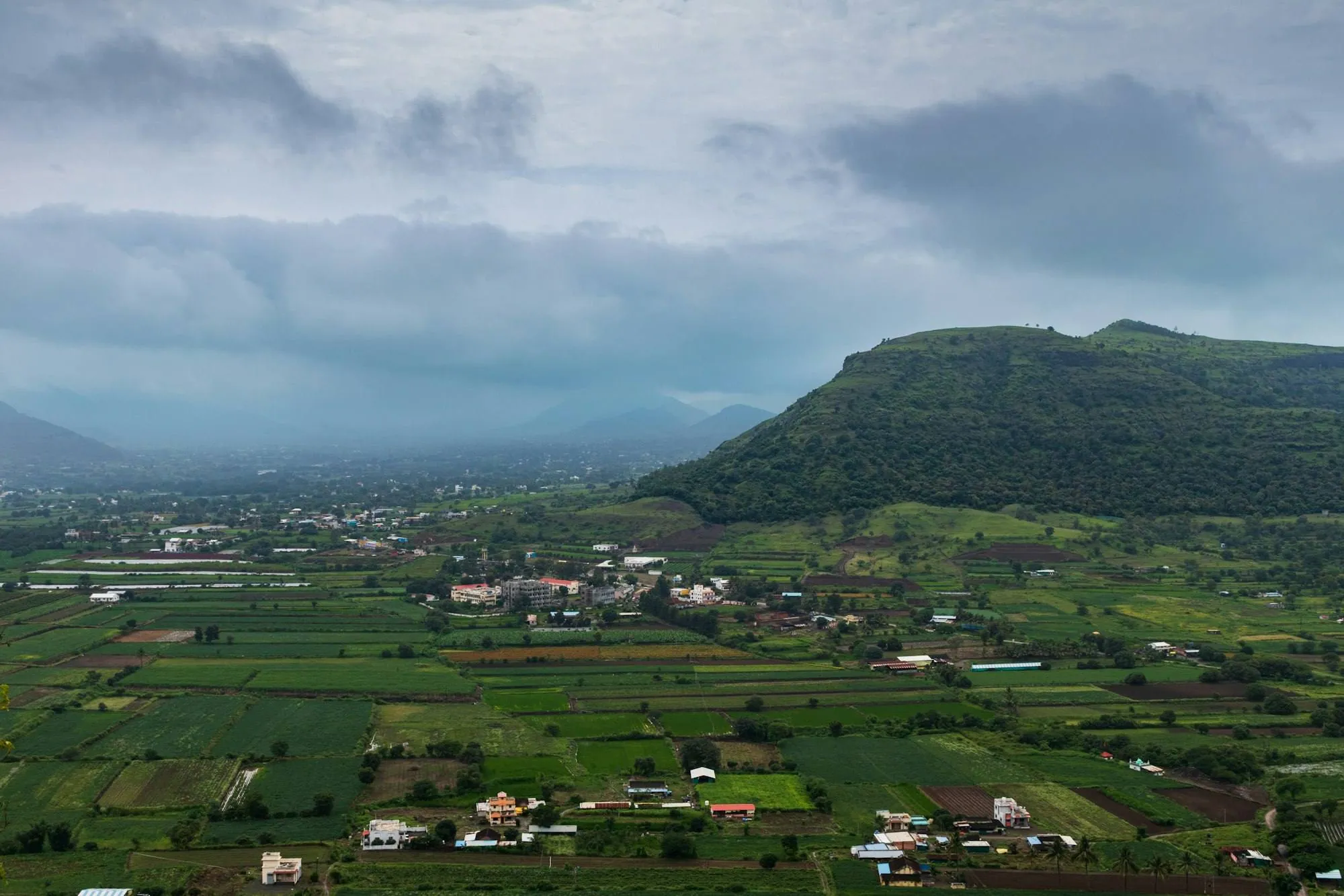 A valley of fields below low hills