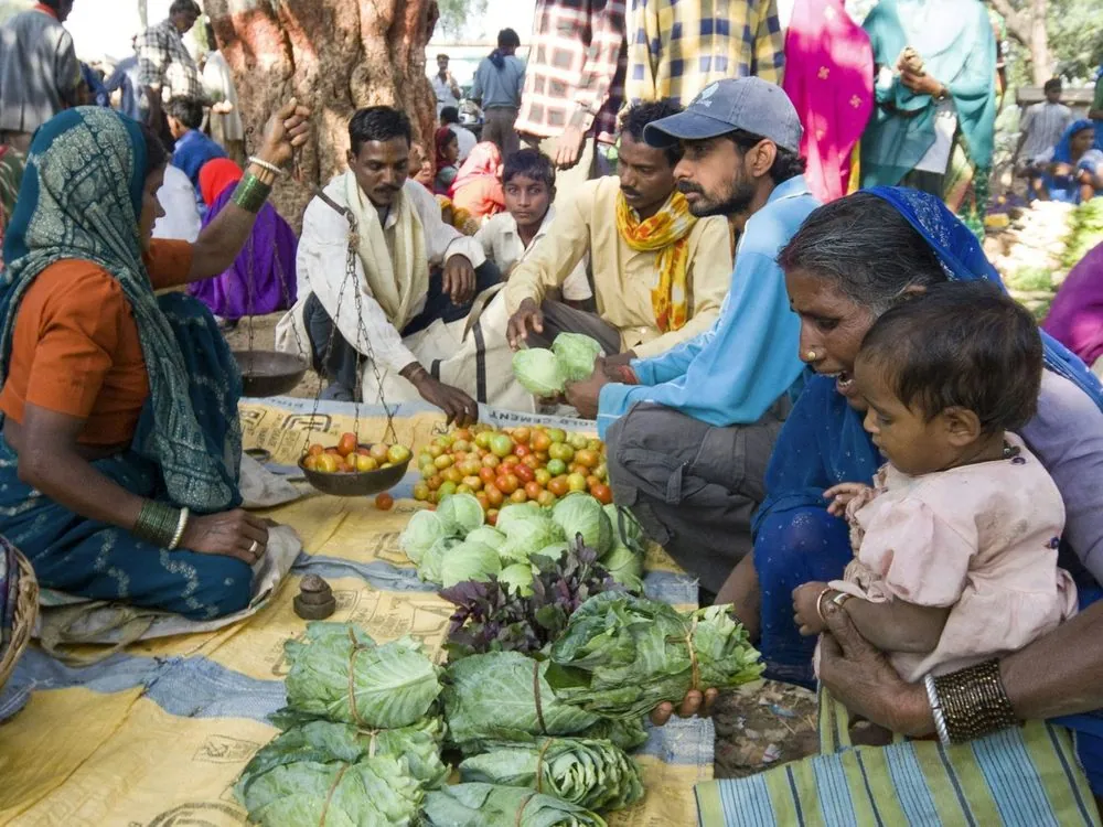 A market scene of produce and buyers