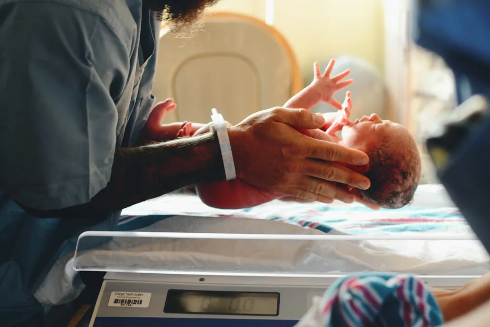 A newborn being weighed