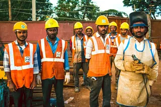 Workers in hard hats and safety gear